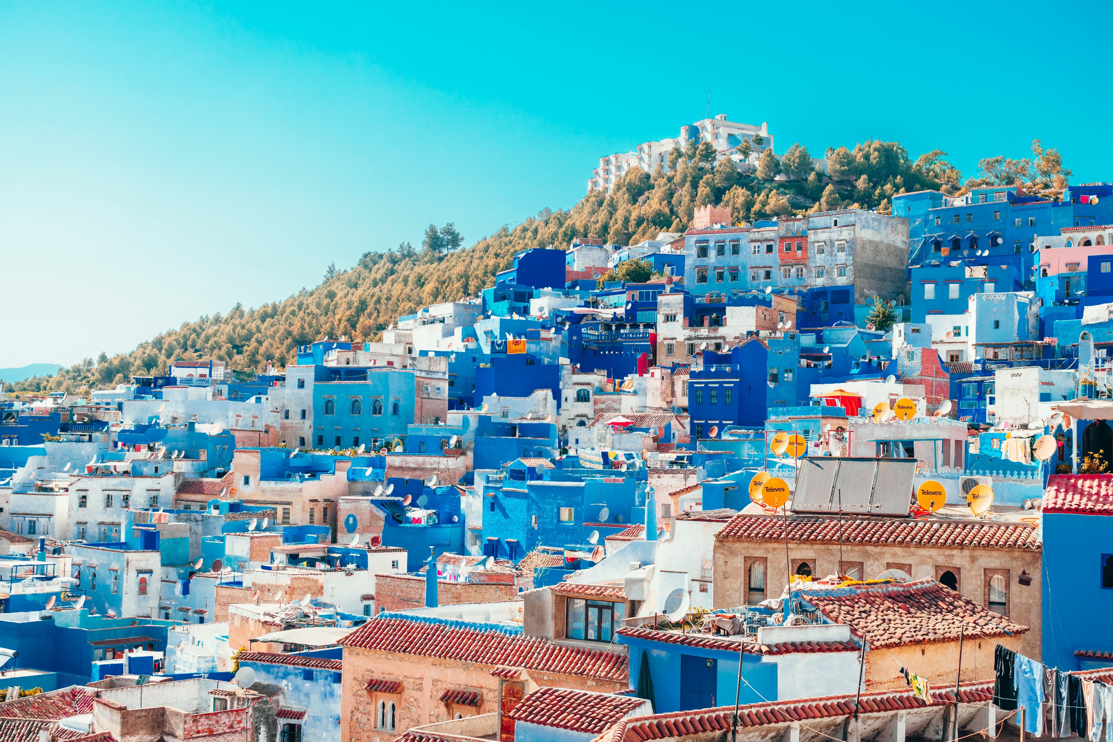Aerial view of Chefchaouen — blue-washed medina on a Rif Mountain hillside, Morocco