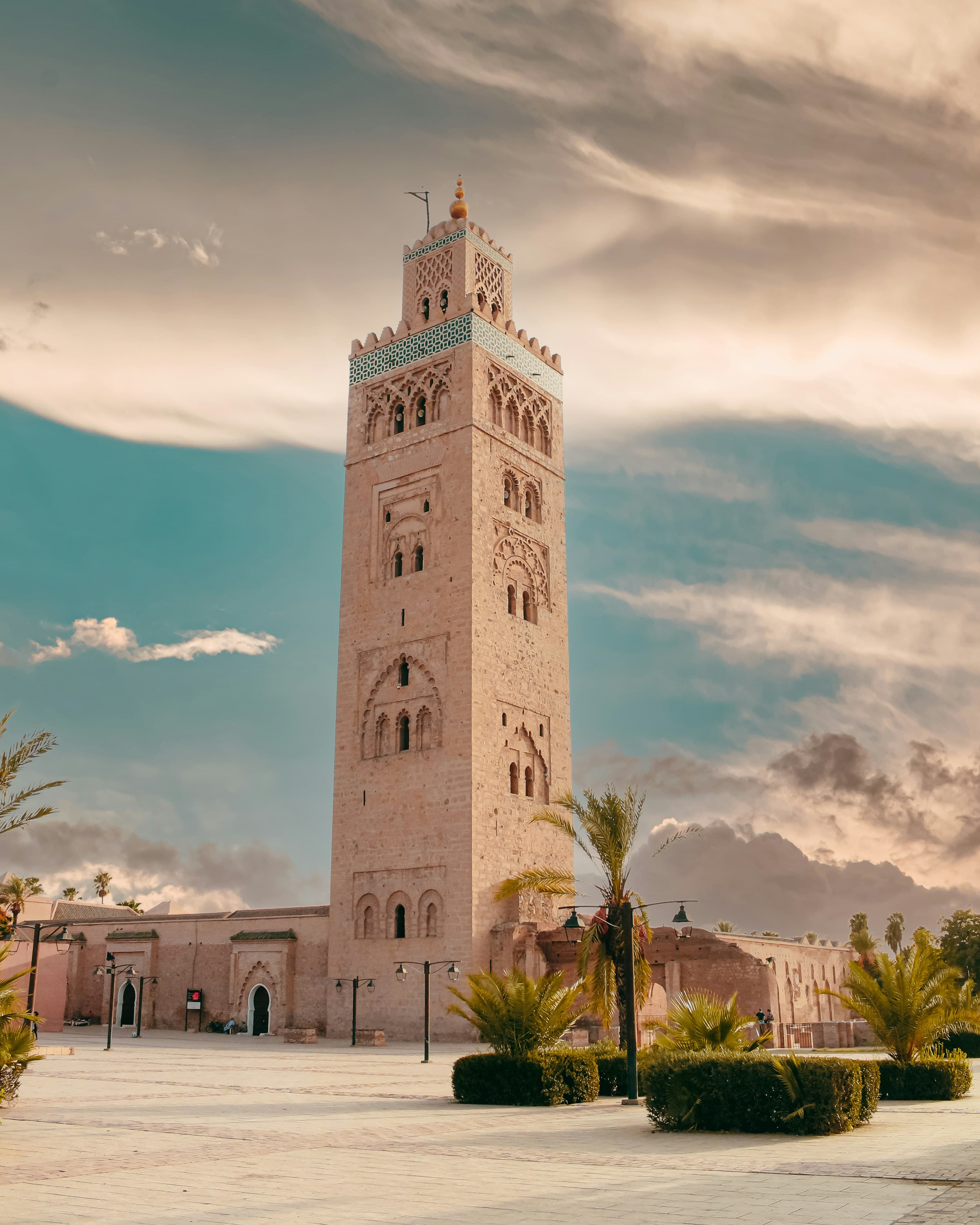 Koutoubia mosque minaret against a dramatic sunset sky, Marrakech medina